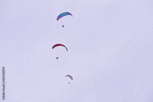 paragliders soar high in the sky