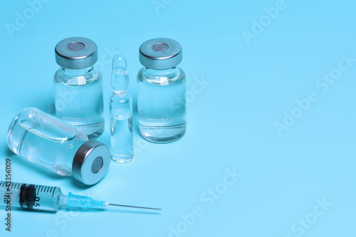 Medicine vials and syringe. Vaccination, Immunization. Fighting the coronavirus pandemic, treating pain, cancer and other diseases. Copy space