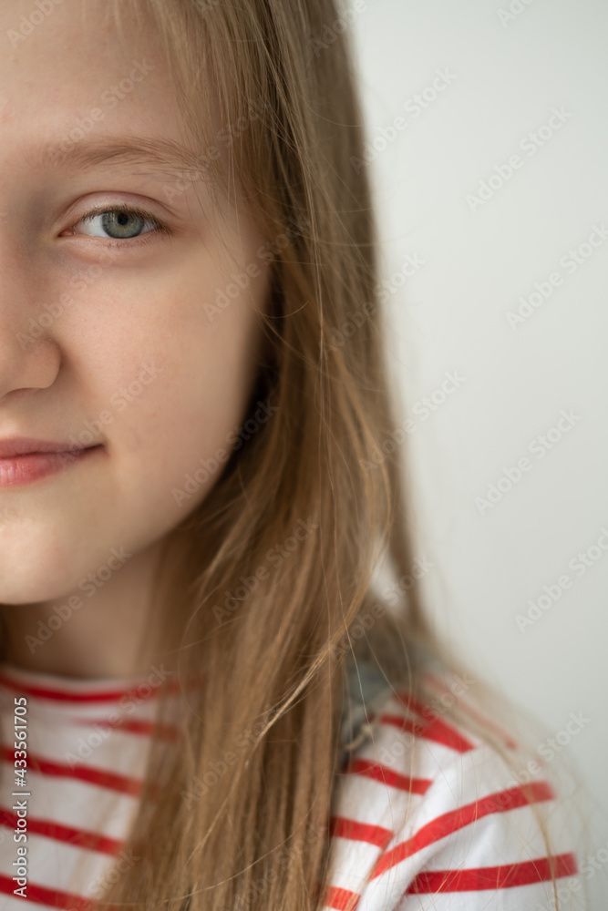 portrait of beautiful teenage girl with long hair smiling standing against white wall portrait of beautiful teenage girl with long hair smiling standing against white wall