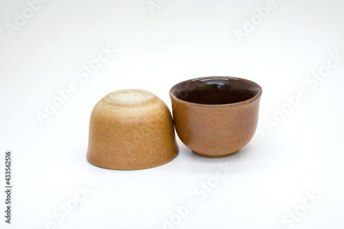 Brown tea cups on white background