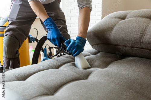 Konstfotografi Man cleaning sofa chemical cleaning with professionally extraction method