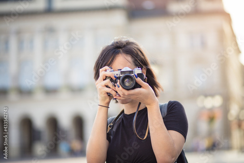  Young woman taking photo in the city with camera. I should definitely get a picture of that.