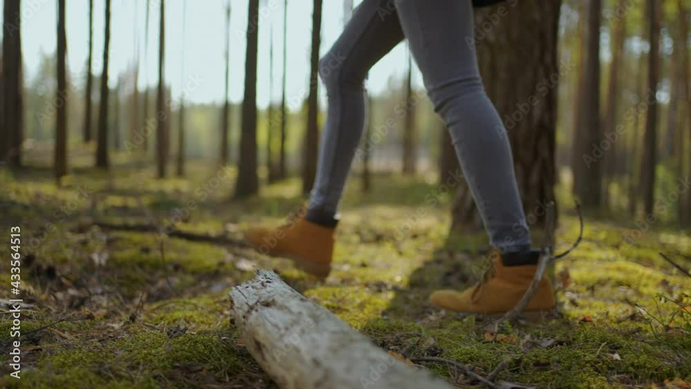Close up of women legs hiking steep terrain in slow motion. Feet in Hiking Boots Walking on Autumn Road. woman feet tracking on fall day outdoors, walking through woodland Close up of women legs hiking steep terrain in slow motion. Feet in Hiking Boots Walking on Autumn Road. woman feet tracking on fall day outdoors, walking through woodland
