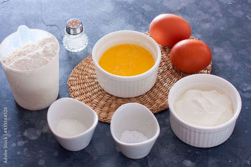 ingredients for unleavened dough - flour, eggs, butter, soda, horizontal ingredients for unleavened dough - flour, eggs, butter, soda, horizontal