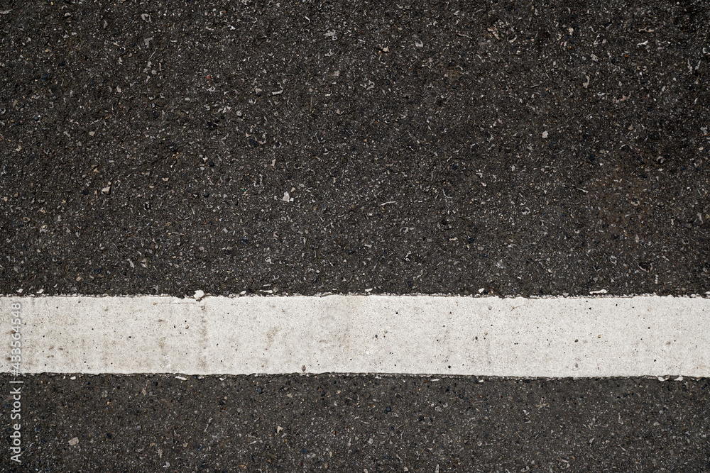 Fototapeta premium Surface grunge rough of asphalt, Seamless tarmac dark grey with white line on the road and small rock, Texture Background, Top view