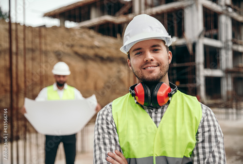Smiling male builder at construction site photo