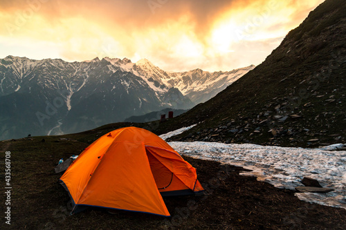 Tent at a campsite at the edge of the Himalayas, seen at sunset, on the Bhrigu Lake trek in northern India