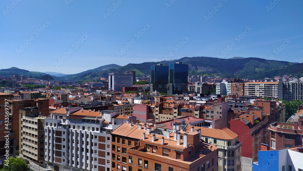 Naklejka premium City view, mountains are visible in the distance.