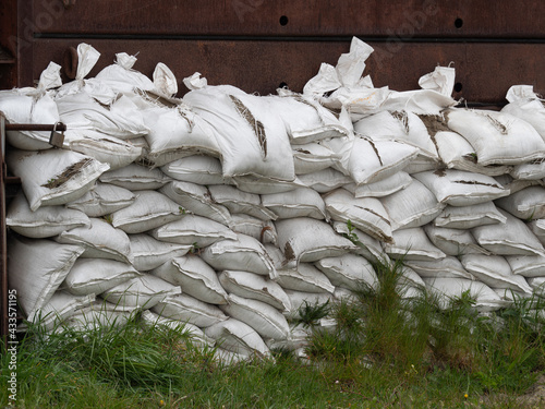 Many white sandbags have been cut to pieces by vandals photo