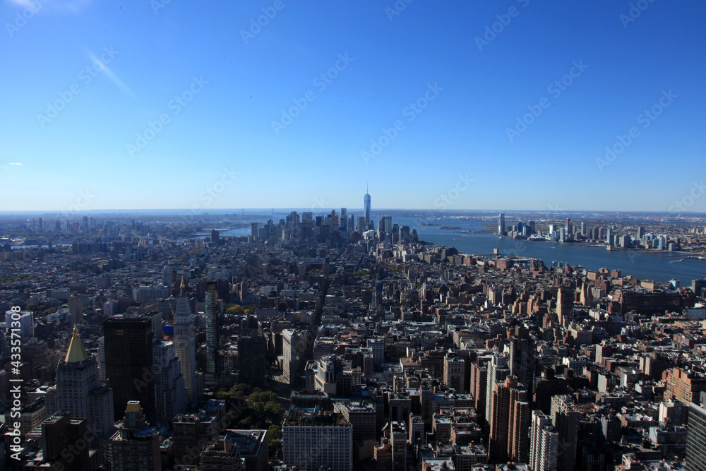 Aerial View Of Citysccity, skyline, manhattan, new york city, view, skyscraper, building, building, architecture, urban, sky, downtown, distance, aerial, new york city, new, new yoape Against Blue Sky