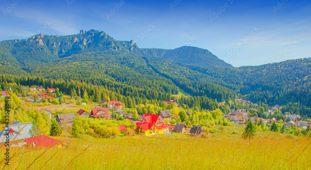 Durau mountain resort in Romanian Carpathians. Ceahlau peak in background. autumn landscape