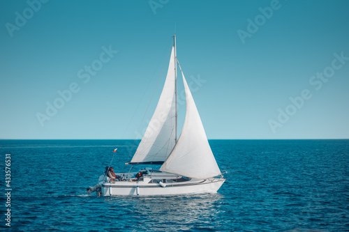 Regatta sailing ship yachts with white sails at opened sea