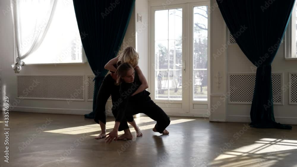 young pair of dancers are rehearsing in hall, contemporary choreography, woman and man are dancing young pair of dancers are rehearsing in hall, contemporary choreography, woman and man are dancing