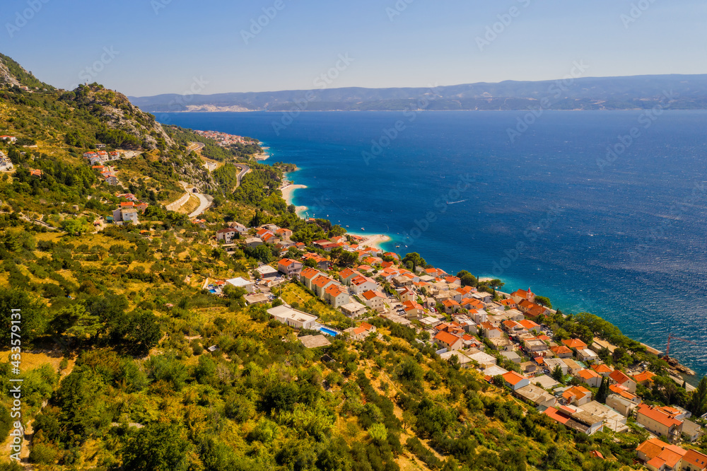 Panorama of town Bol on Brac island in Croatia - travel background. Aerial drone picture in august 2020
