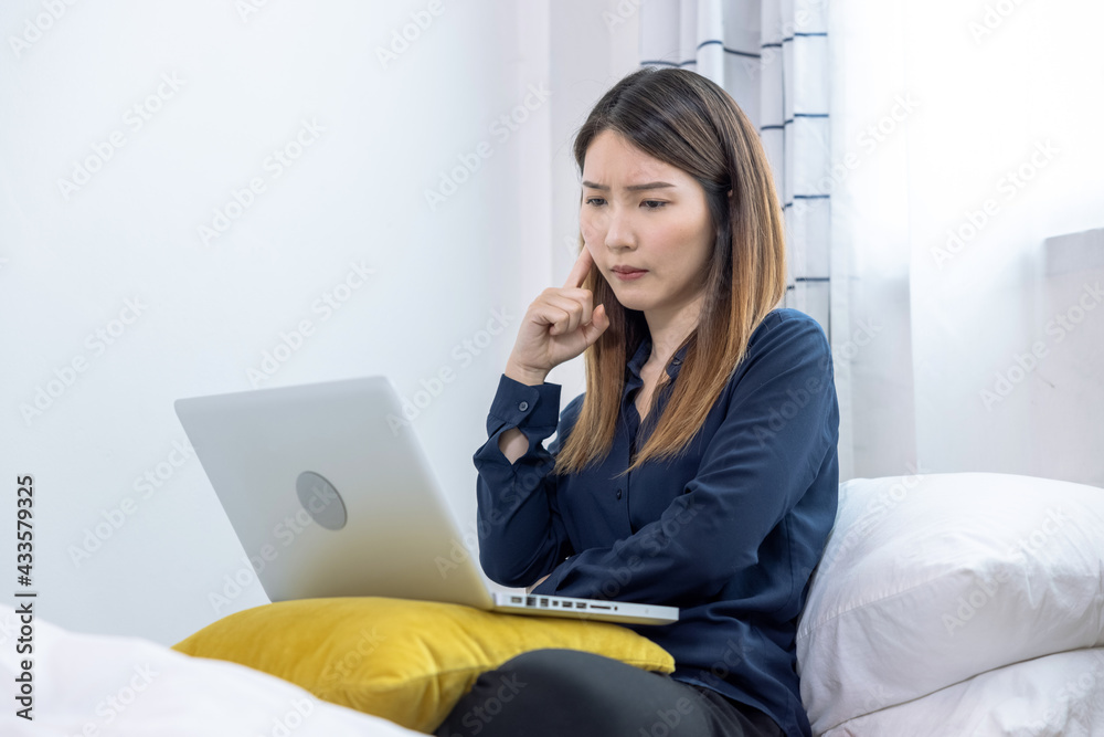 Asian woman uses a laptop computer to work at home, She was stressed and exhausted from work for a long time. Asian woman uses a laptop computer to work at home, She was stressed and exhausted from work for a long time.