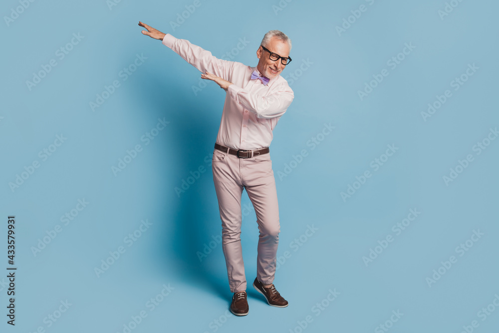 Photo of crazy dancing gentleman on blue color background Photo of crazy dancing gentleman on blue color background
