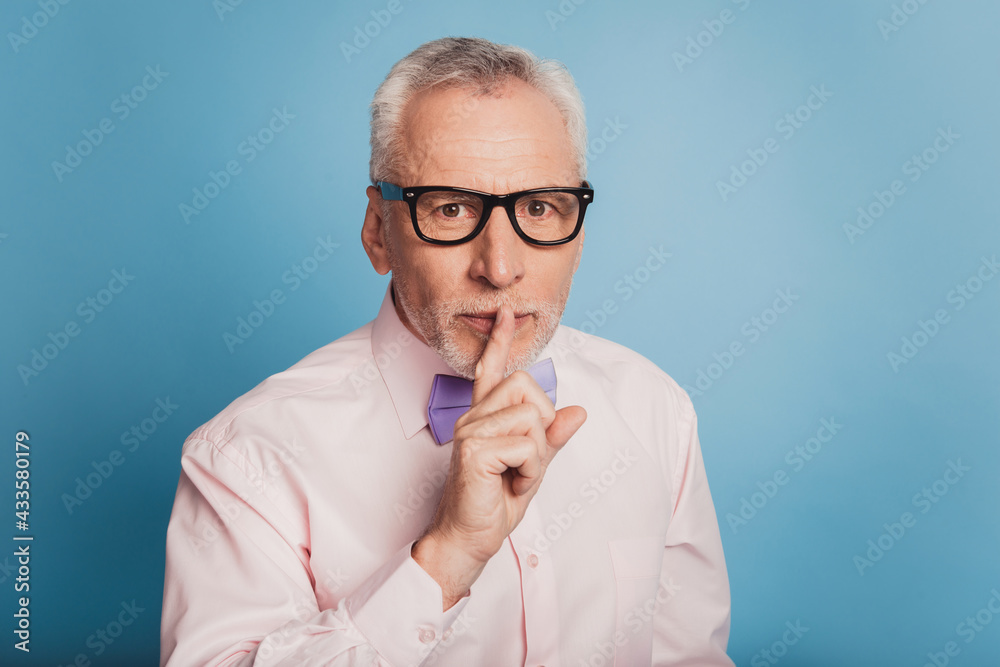 Photo of elegant man holding finger on lips Photo of elegant man holding finger on lips
