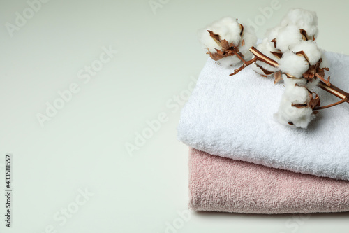 Clean folded towels and cotton on white background
