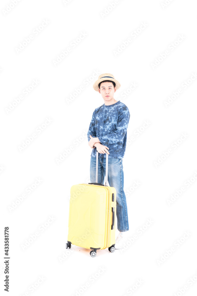 A young Asian tourist stands with a yellow suitcase on a white background. A young Asian tourist stands with a yellow suitcase on a white background.