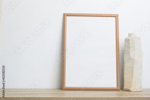 A mock up photo frame on a white wall.