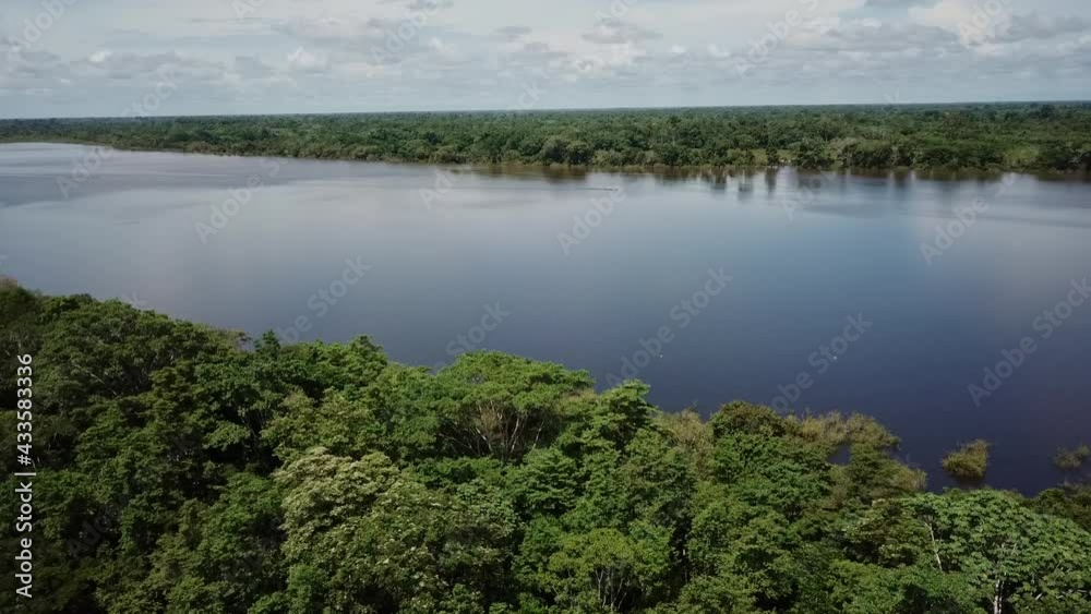 Aerial Establishing Shot Of Calm Lake Surrounded By Tropical Rainforest In Peru. Dolly Forward Aerial Establishing Shot Of Calm Lake Surrounded By Tropical Rainforest In Peru. Dolly Forward