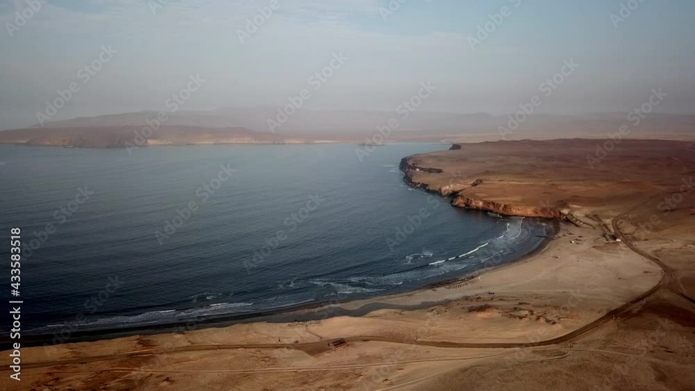 Soothing ocean waves meet Barren desert coastline of Paracas, Peru - Aerial Soothing ocean waves meet Barren desert coastline of Paracas, Peru - Aerial