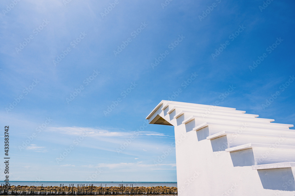 Beautiful seascape and blue sky with white staircase to the sky beside the sea in thailand.