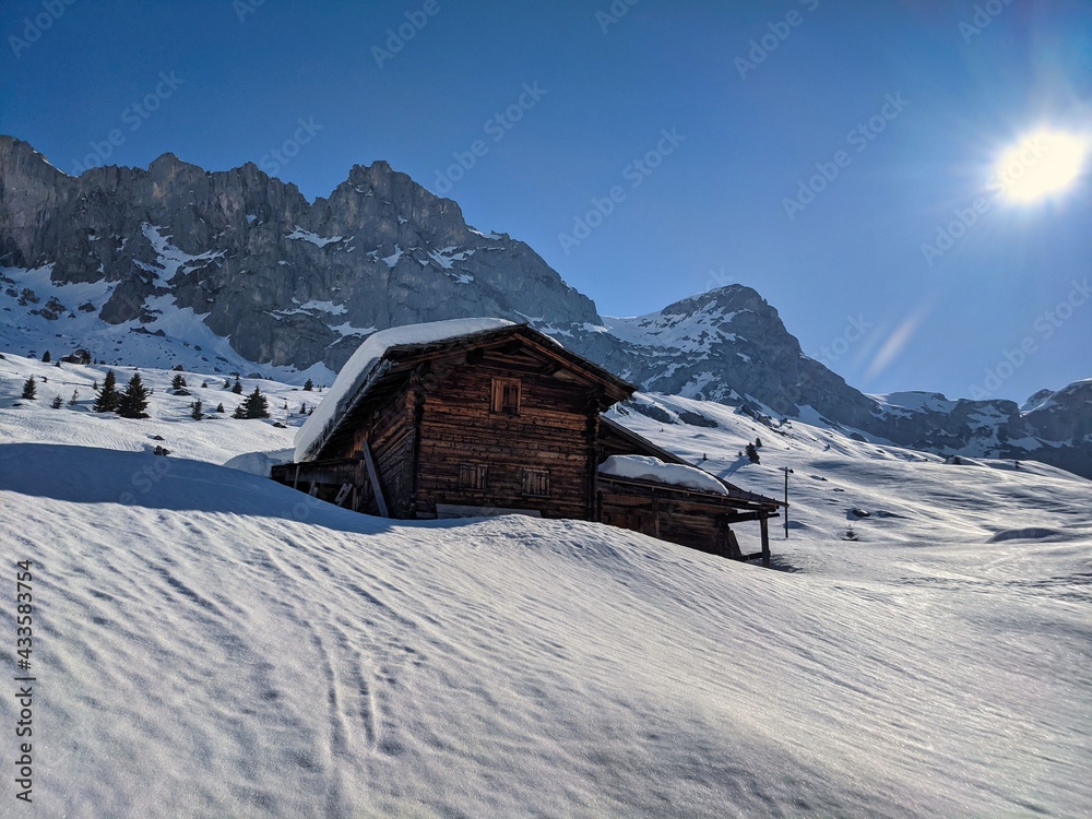 wooden hut on the alp partnun in the canton of grisons. good ski touring region. beautiful winter morning, switzerland