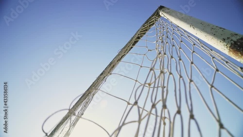 The ball hits the corner of the goal. The footballer scores a goal. Winning the championship. Football concept. Beautiful goal against the blue sky. Bottom view