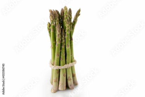 Raw fresh bunch of green asparagus isolated on white background