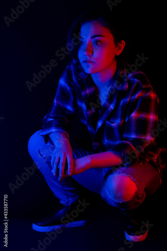 Portrait of teen with blue and red light