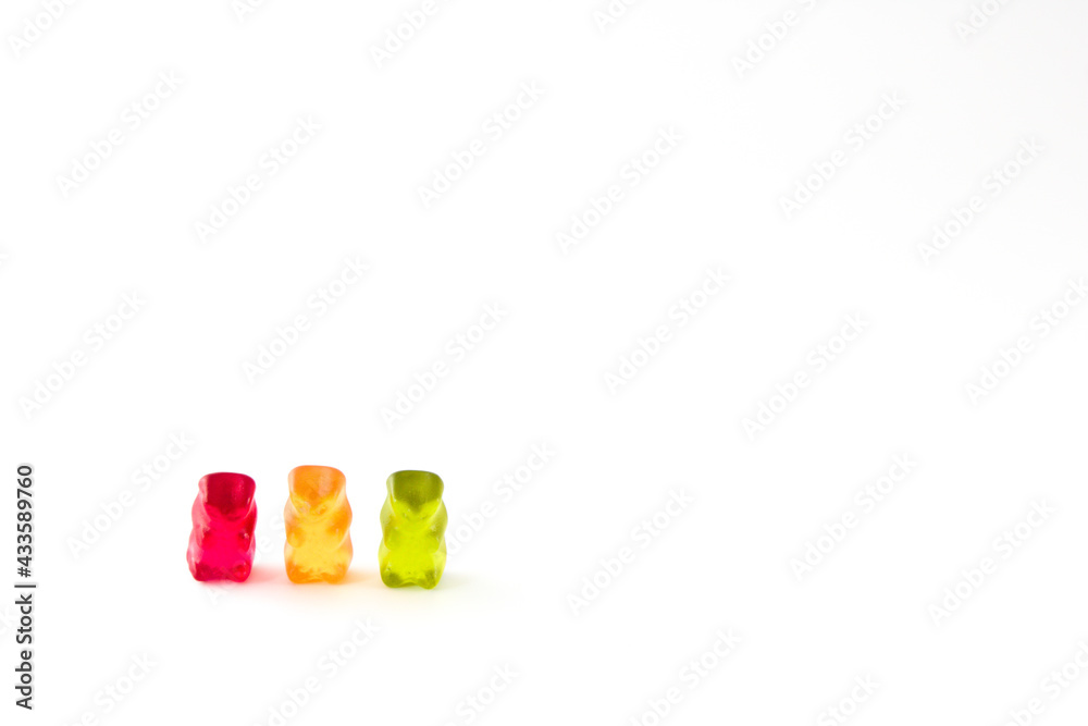 Group of three gummy bears in traffic lights colours, isolated on white background with copy space Group of three gummy bears in traffic lights colours, isolated on white background with copy space