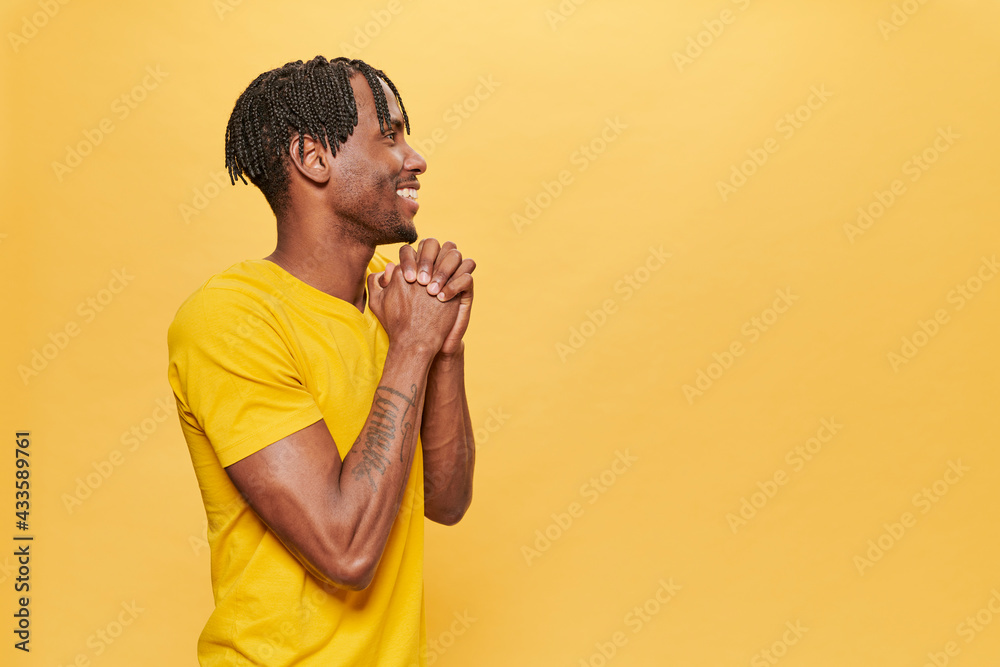 Handsome Afro Man Posing Over Yellow Background wearing yellow t-shirt Handsome Afro Man Posing Over Yellow Background wearing yellow t-shirt