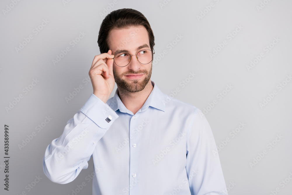 Portrait of attractive imposing man expert touching specs looking aside deciding isolated over grey pastel color background Portrait of attractive imposing man expert touching specs looking aside deciding isolated over grey pastel color background