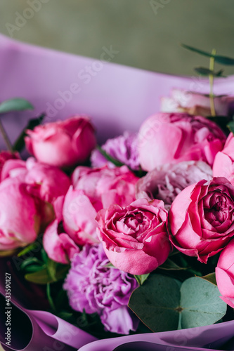 Bright bouquet of pink peonies  roses and carnations of different shades. Summer background