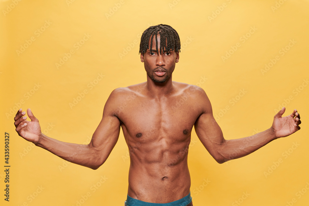 Shirtless Muscle Black Man Over Yellow Background 
