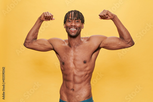 Shirtless Muscle Black Man Over Yellow Background 