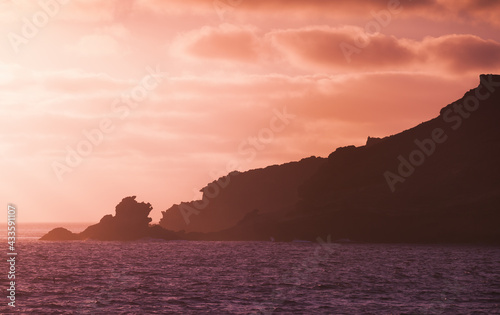 Landscape with coastal rocks on a sunset