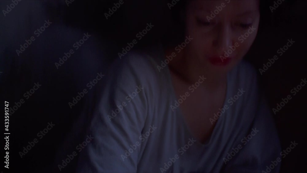 Girl is chatting online in the phone at night