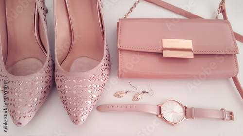 Closeup of pink and rose gold beauty fashion items accessories, watch, earrings, pumps and clutch, outfit for a wedding, accessory and clothing