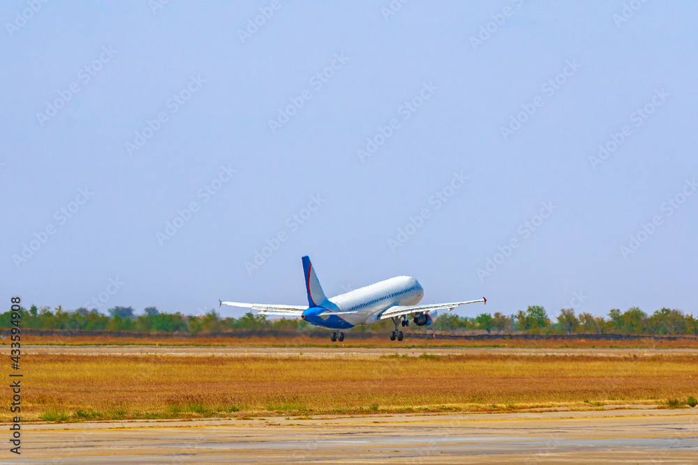 Passenger plane takes off from runway in airport Passenger plane takes off from runway in airport