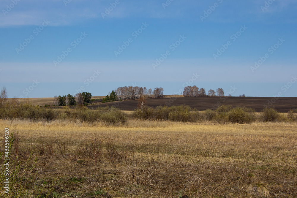 Spring fields under a clear sky. Ural rural landscapes