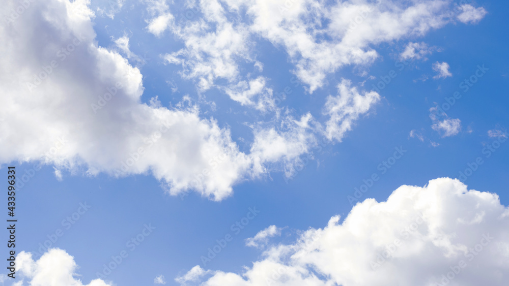 blue sky with white clouds backlit by sunlight blue sky with white clouds backlit by sunlight