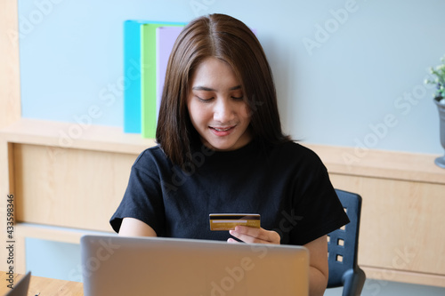  Online payment with Young Women hands holding credit card and using computer for online shopping