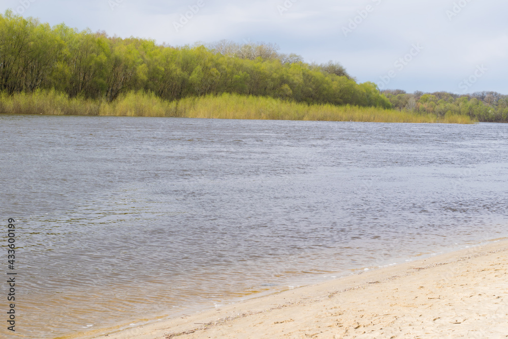 City beach on the banks of the Desna River in Ukraine in the city of Chernigov. Spring, preparing for the beach season