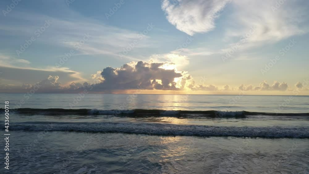 Beach view during sunrise with significant orange cloud Beach view during sunrise with significant orange cloud