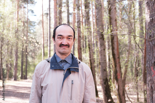 Half-length portrait of serious senior Asian man.