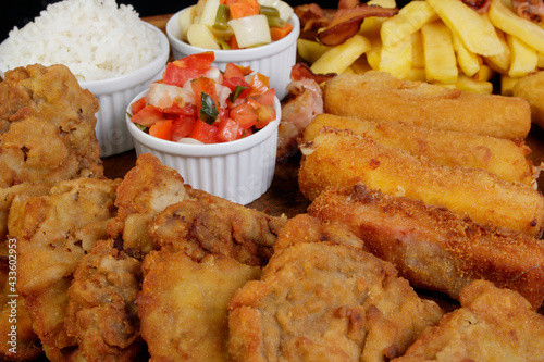 Fototapeta Naklejka Na Ścianę i Meble -  Cuban fillet. Made with breaded Steak, cheese, breaded ham and banana, Vinaigrette, white rice. Gourmet photo of tropical food.