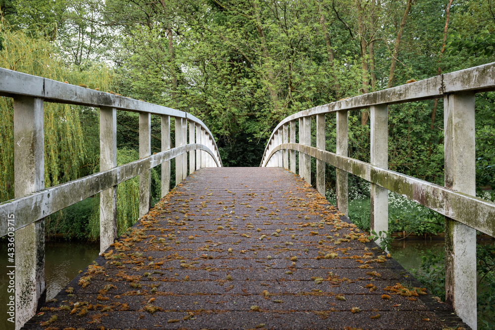 Symmetrical lines of the old, white, isolated wooden bridge in the city of Breda, North Brabant Symmetrical lines of the old, white, isolated wooden bridge in the city of Breda, North Brabant