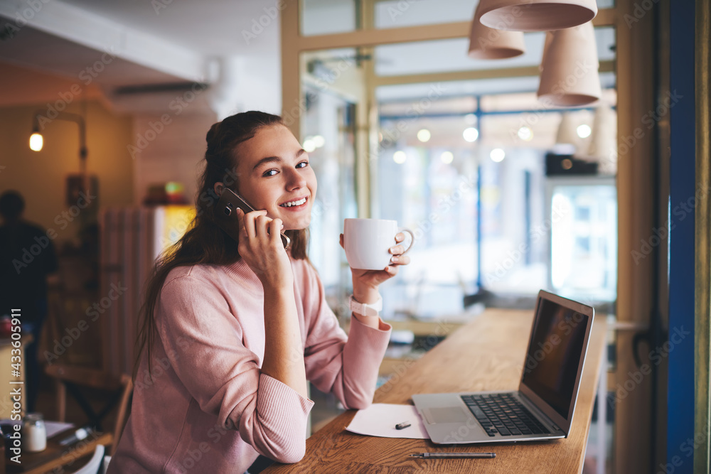 custom made wallpaper toronto digitalSatisfied woman speaking on smartphone in cafe